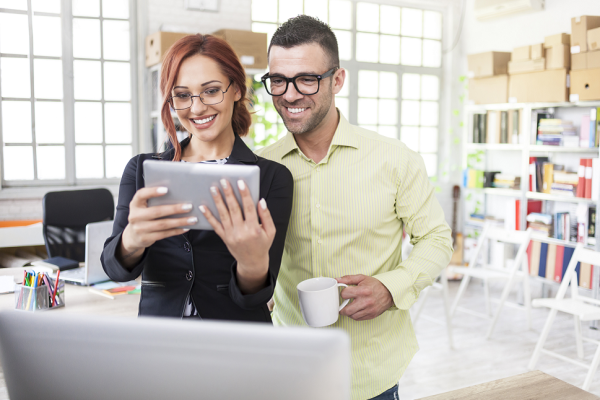 colleagues working on a mobile device in a small medium business