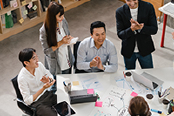 Young professional communicating with coworkers at a virtual meeting.