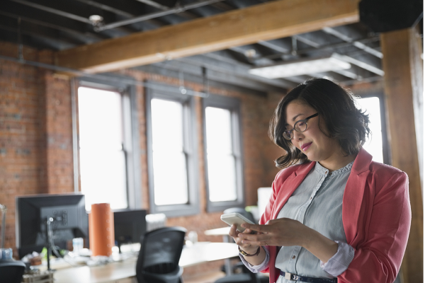 Lady working with her own mobile device in a small medium business