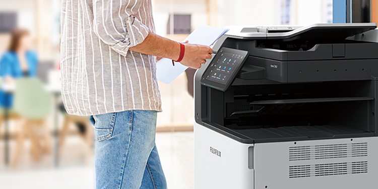 A multifunction printer placed in the corner of an office